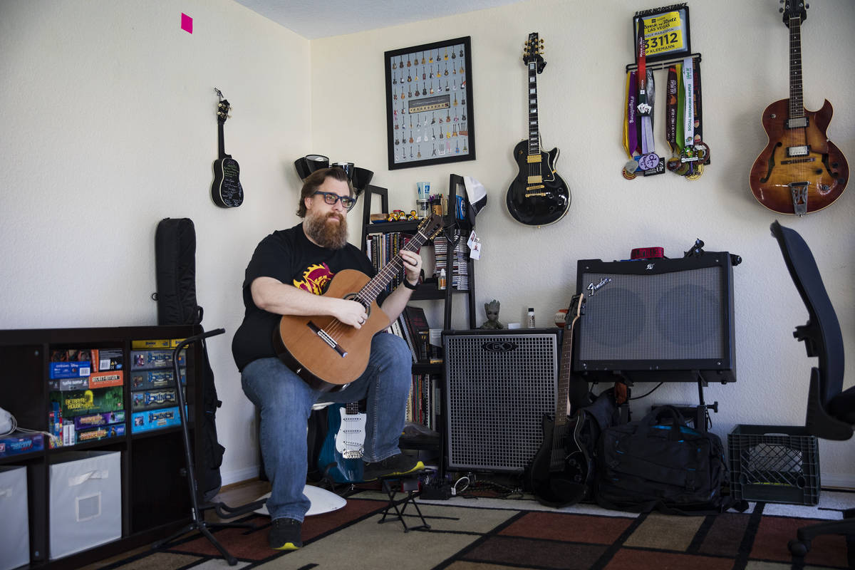 Paul Kleemann, a guitar director at Del Sol Academy, plays guitar at his home in Las Vegas in L ...