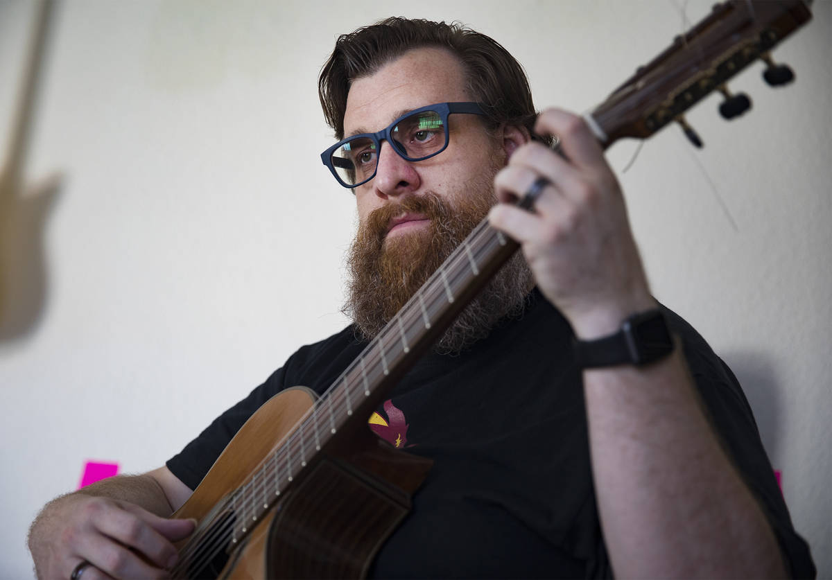 Paul Kleemann, a guitar director at Del Sol Academy, plays guitar at his home in Las Vegas in L ...