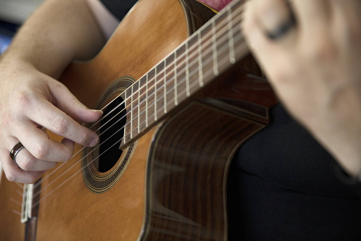 Paul Kleemann, a guitar director at Del Sol Academy, plays guitar at his home in Las Vegas in L ...