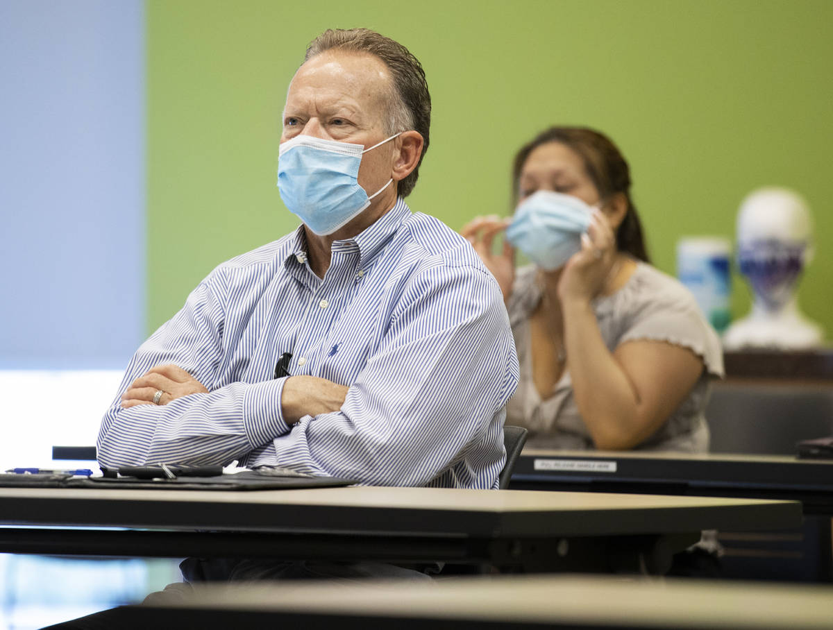 Attendees listen to a presentation from Bob Gronauer, out of frame, a partner with Kaempfer Cr ...