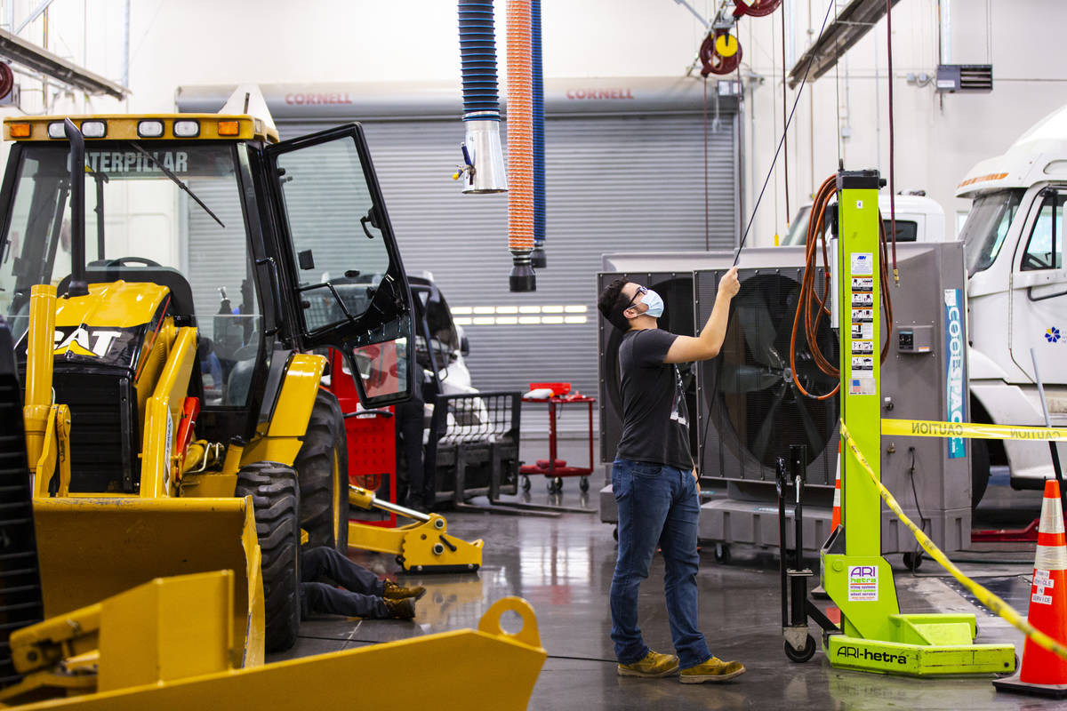 Student Samuel Branch, of Henderson, grabs a cord during a diesel hydraulics class at the Colle ...