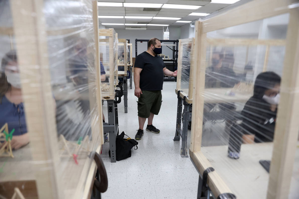 Dave Rowe, associate professor of sculpture practices, talks to a student during an art class a ...