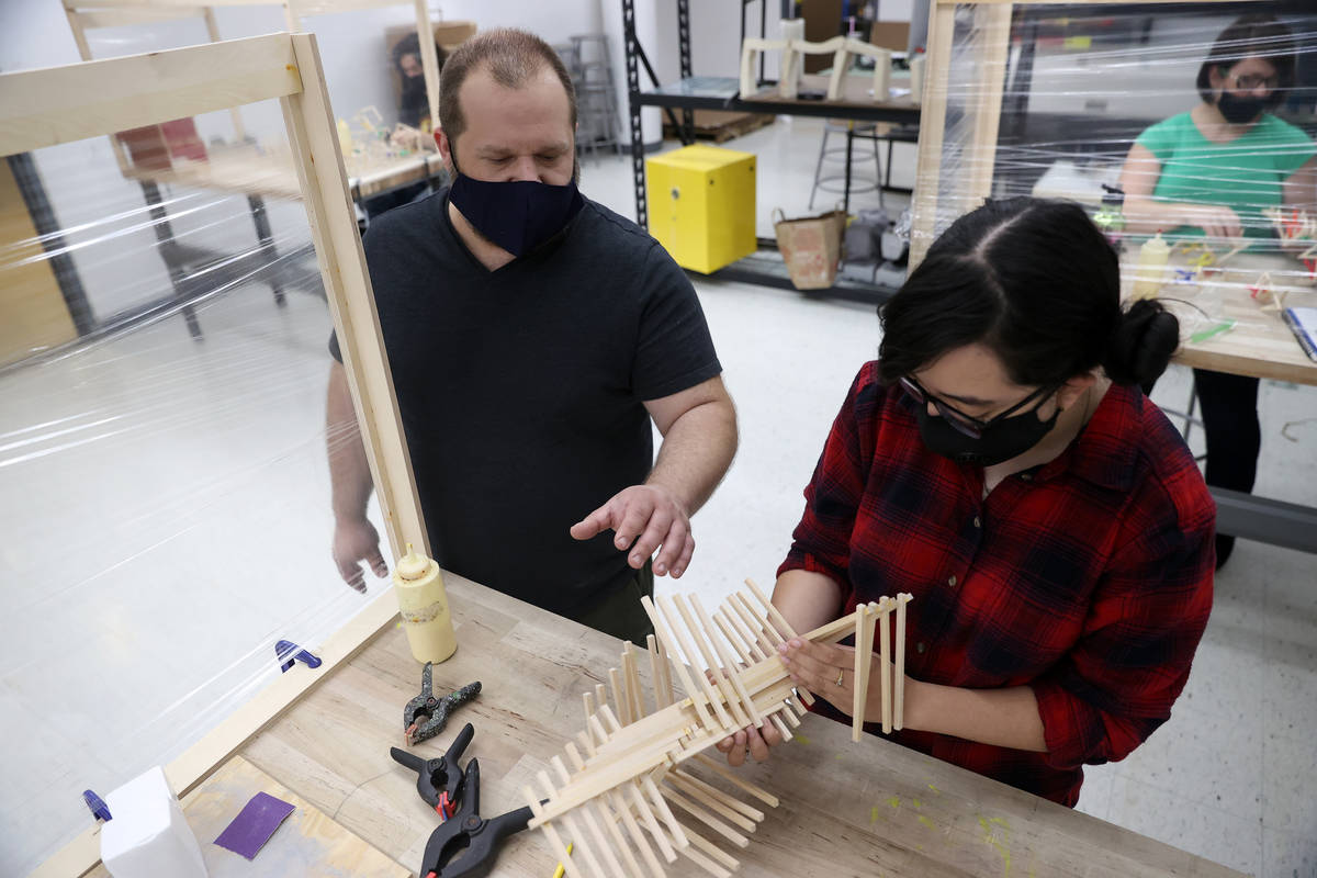 Raquel Cortez, 19, right, receives assistant from her art teacher Dave Rowe during an art class ...