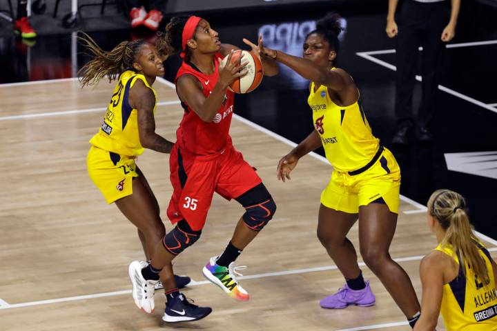 Las Vegas Aces forward Angel McCoughtry (35) shoots between Indiana Fever guard Tiffany Mitchel ...