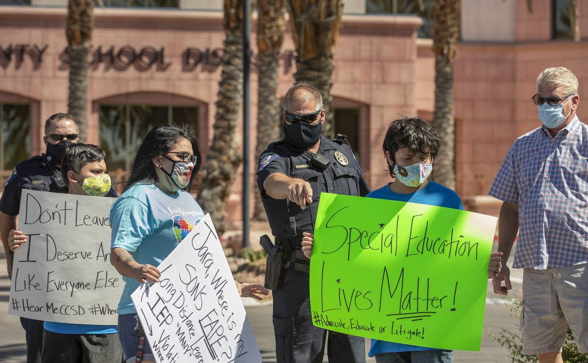 Clark County School District officers direct parents and students off the administration center ...