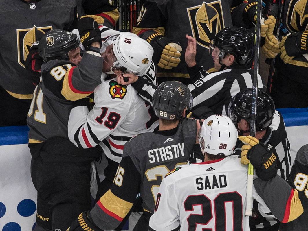 Chicago Blackhawks' Jonathan Toews (19) and Vegas Golden Knights' Jonathan Marchessault (81) ro ...