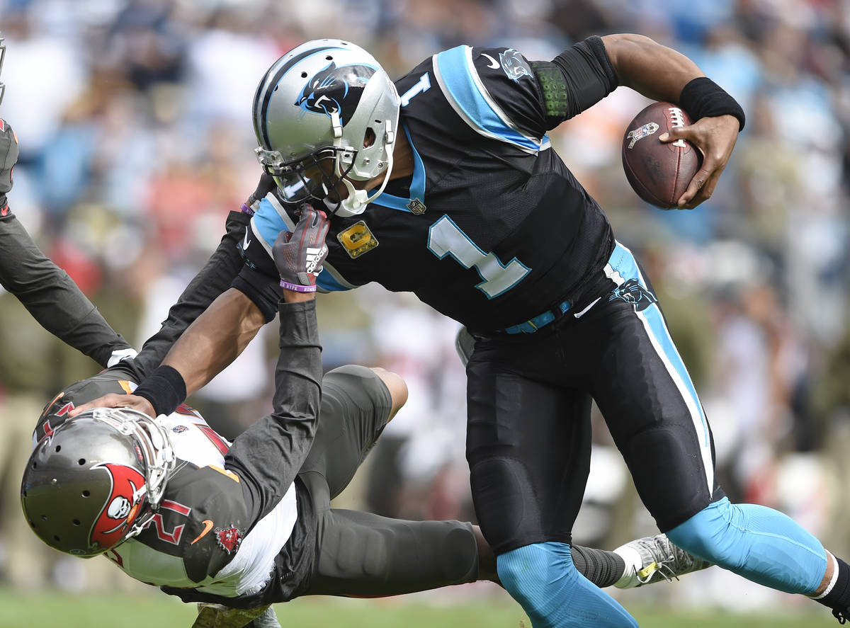 Tampa Bay Buccaneers' Justin Evans (21) grabs the face mask of Carolina Panthers' Cam Newton (1 ...