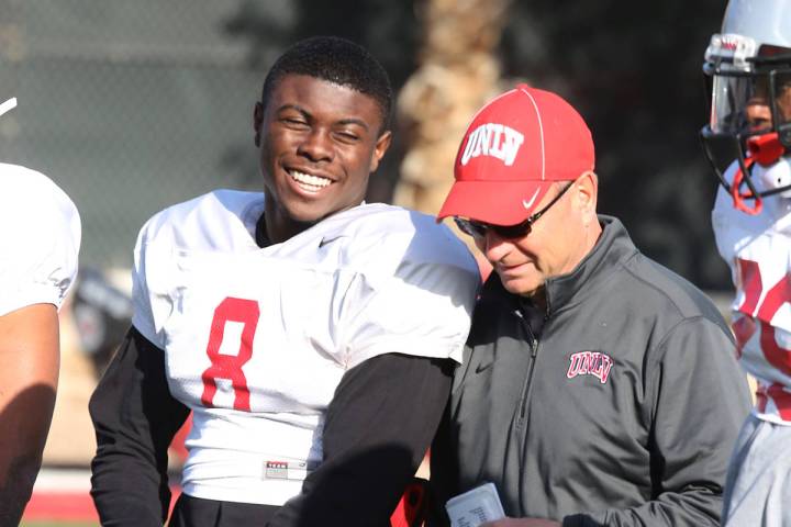 UNLV running back Charles Williams (8) chats with UNLV's Director of Athletic Training Kyle Wil ...