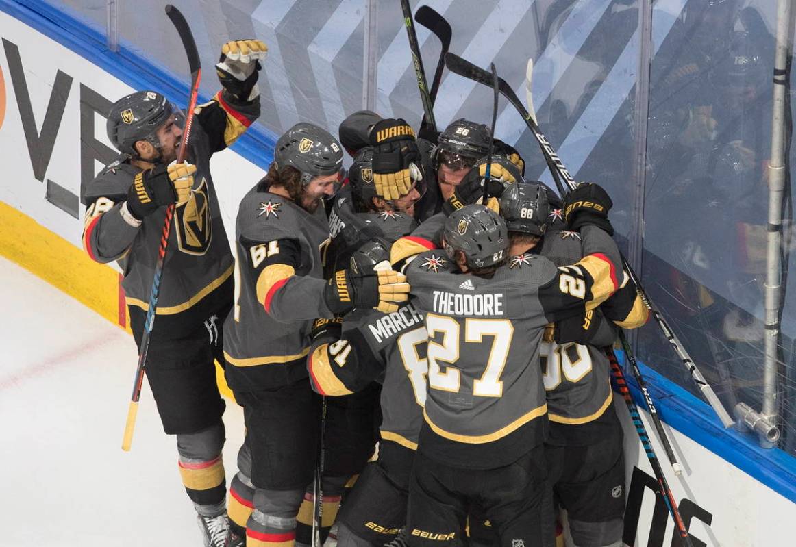 Vegas Golden Knights players celebrate their win over the Chicago Blackhawks after an NHL hocke ...