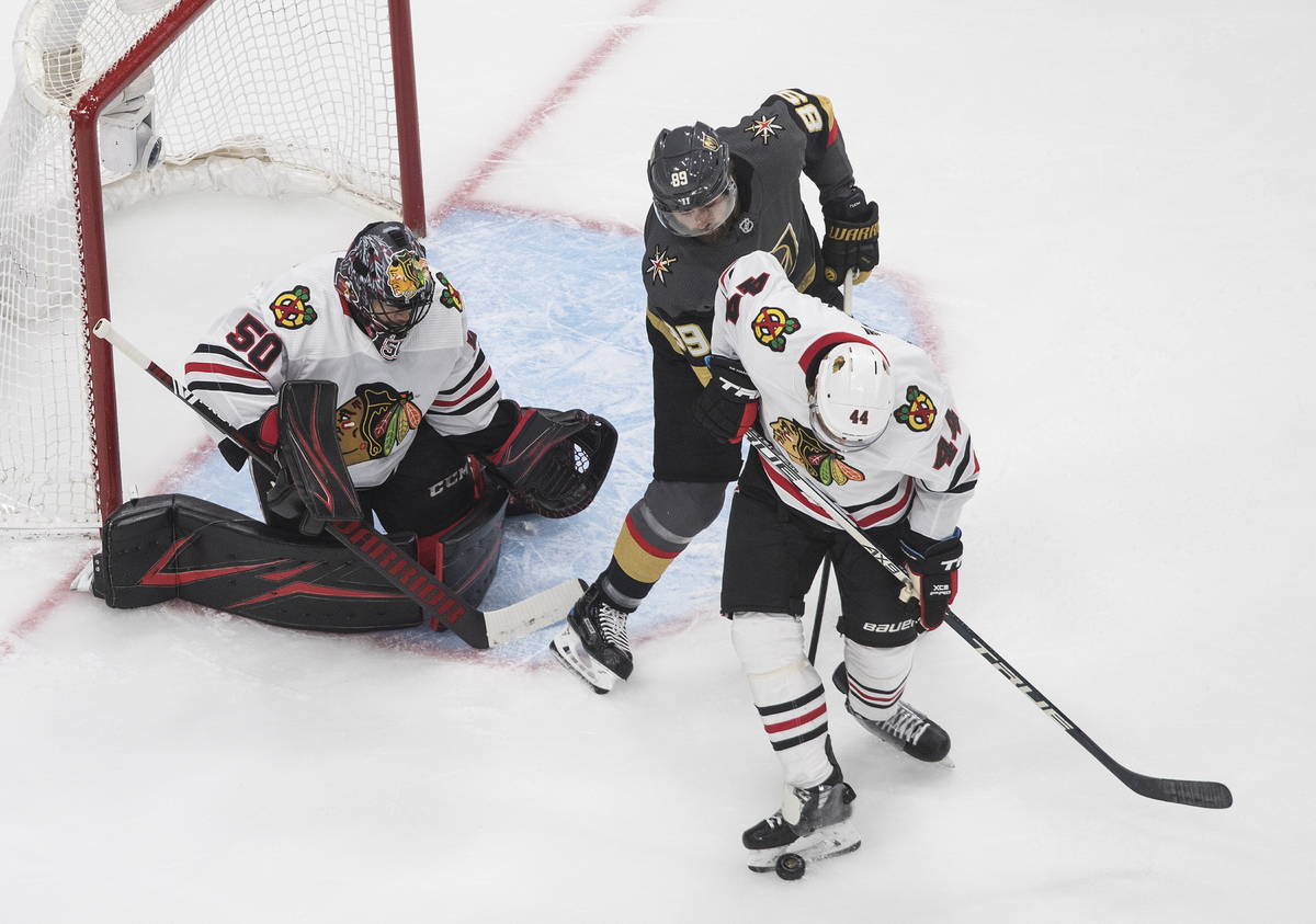 Vegas Golden Knights' Alex Tuch (89) and Chicago Blackhawks' Calvin de Haan (44) battle as Blac ...