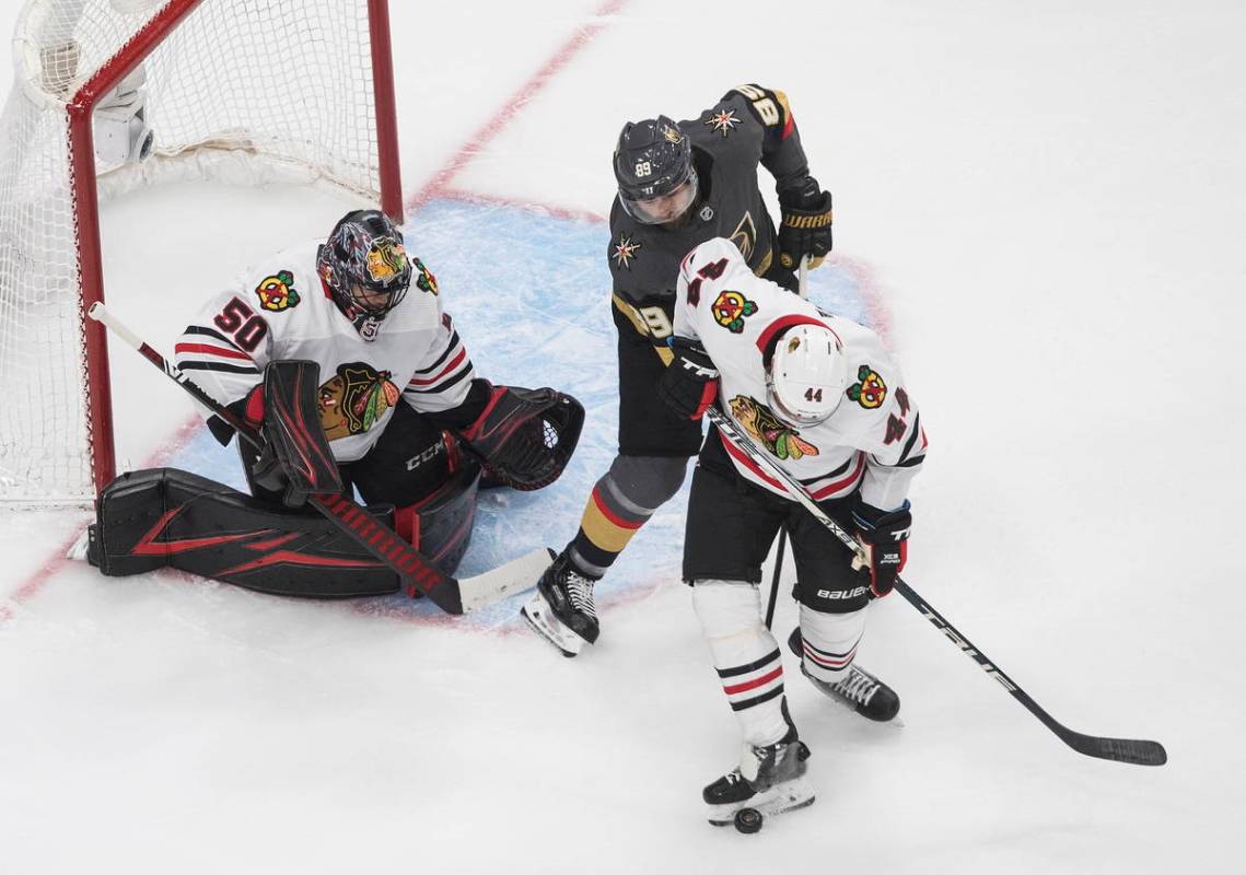 Vegas Golden Knights' Alex Tuch (89) and Chicago Blackhawks' Calvin de Haan (44) battle as Blac ...