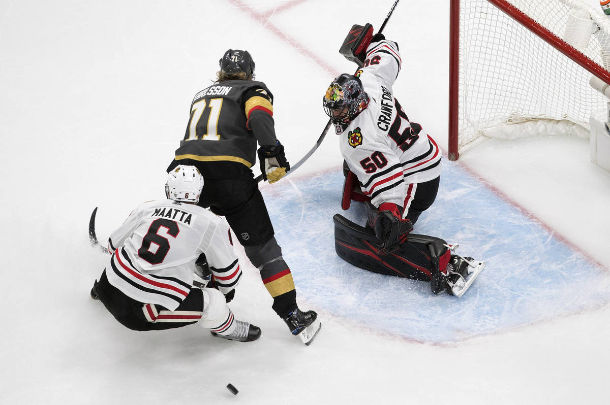 Vegas Golden Knights' William Karlsson (71) is stopped by Chicago Blackhawks goalie Corey Crawf ...