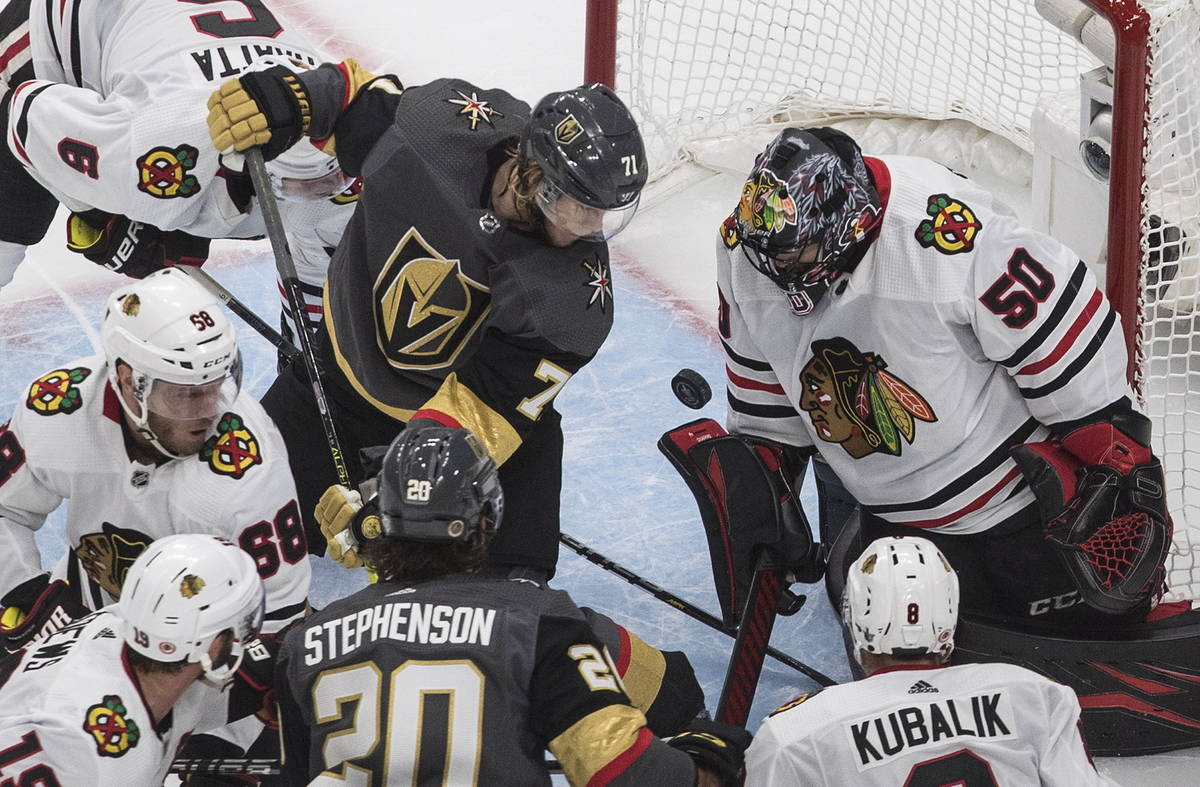 Vegas Golden Knights' William Karlsson (71) is stopped by Chicago Blackhawks goalie Corey Crawf ...