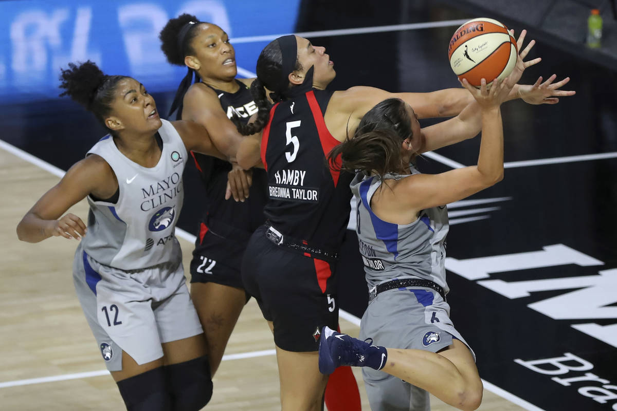 Minnesota Lynx's Bridget Carleton (6) is defended by Las Vegas Aces' Dearica Hamby as Damiris D ...