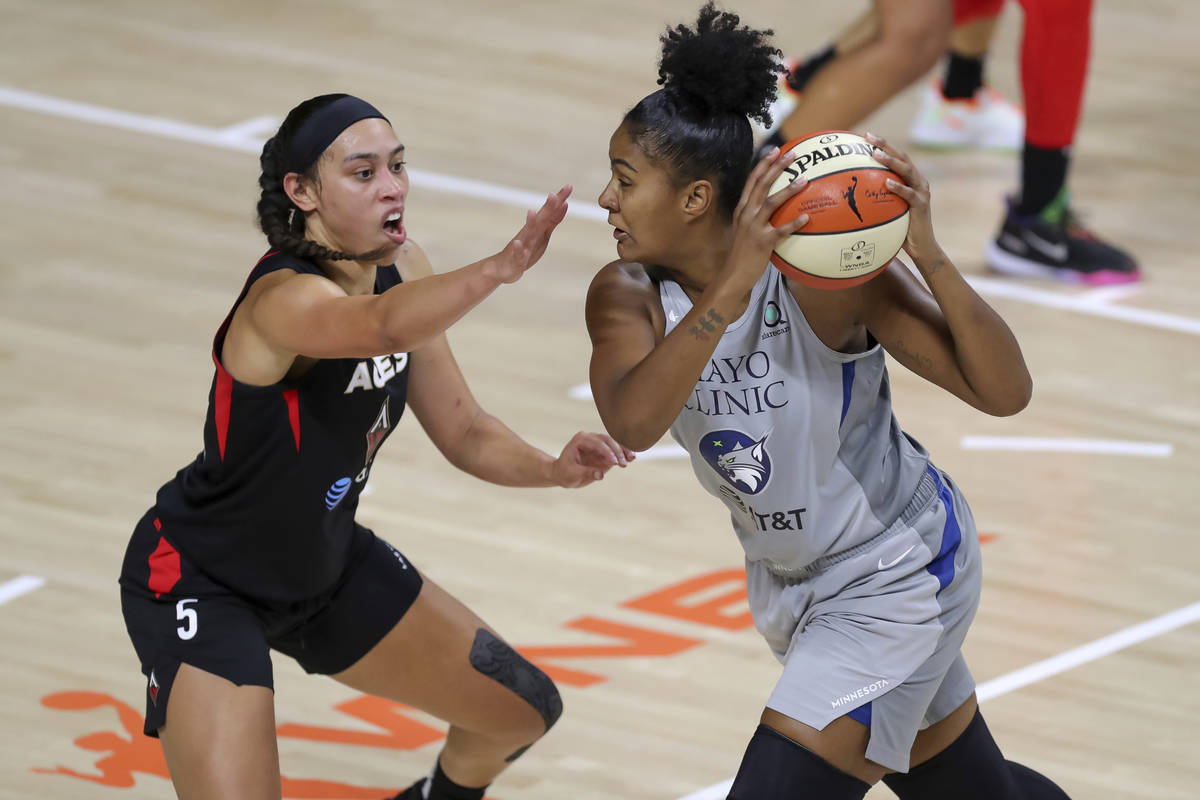 Las Vegas Aces' Dearica Hamby (5) defends against Minnesota Lynx's Damiris Dantas during the se ...