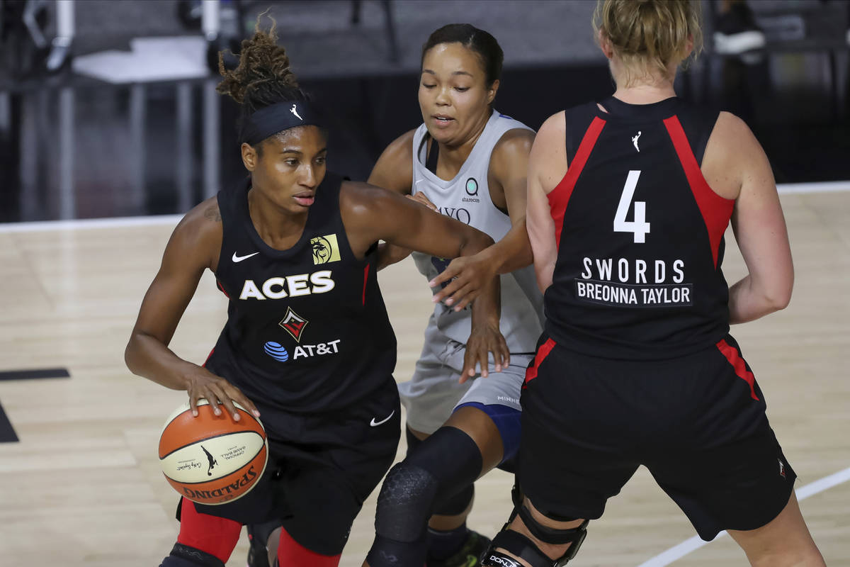 Las Vegas Aces' Angel McCoughtry, left, drives past the defense of Minnesota Lynx's Napheesa Co ...