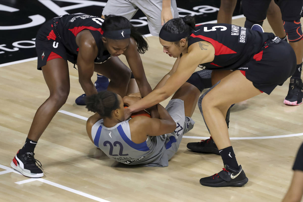 Minnesota Lynx's Erica McCall (22) tries to keep the ball away from Las Vegas Aces' Jackie Youn ...