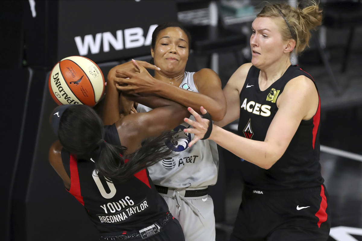 Las Vegas Aces' Jackie Young (0) knocks the ball away from Minnesota Lynx's Napheesa Collier as ...