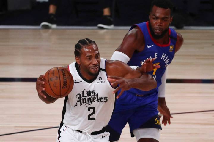 Los Angeles Clippers' forward Kawhi Leonard (2) drives to the basket past Denver Nuggets forwar ...