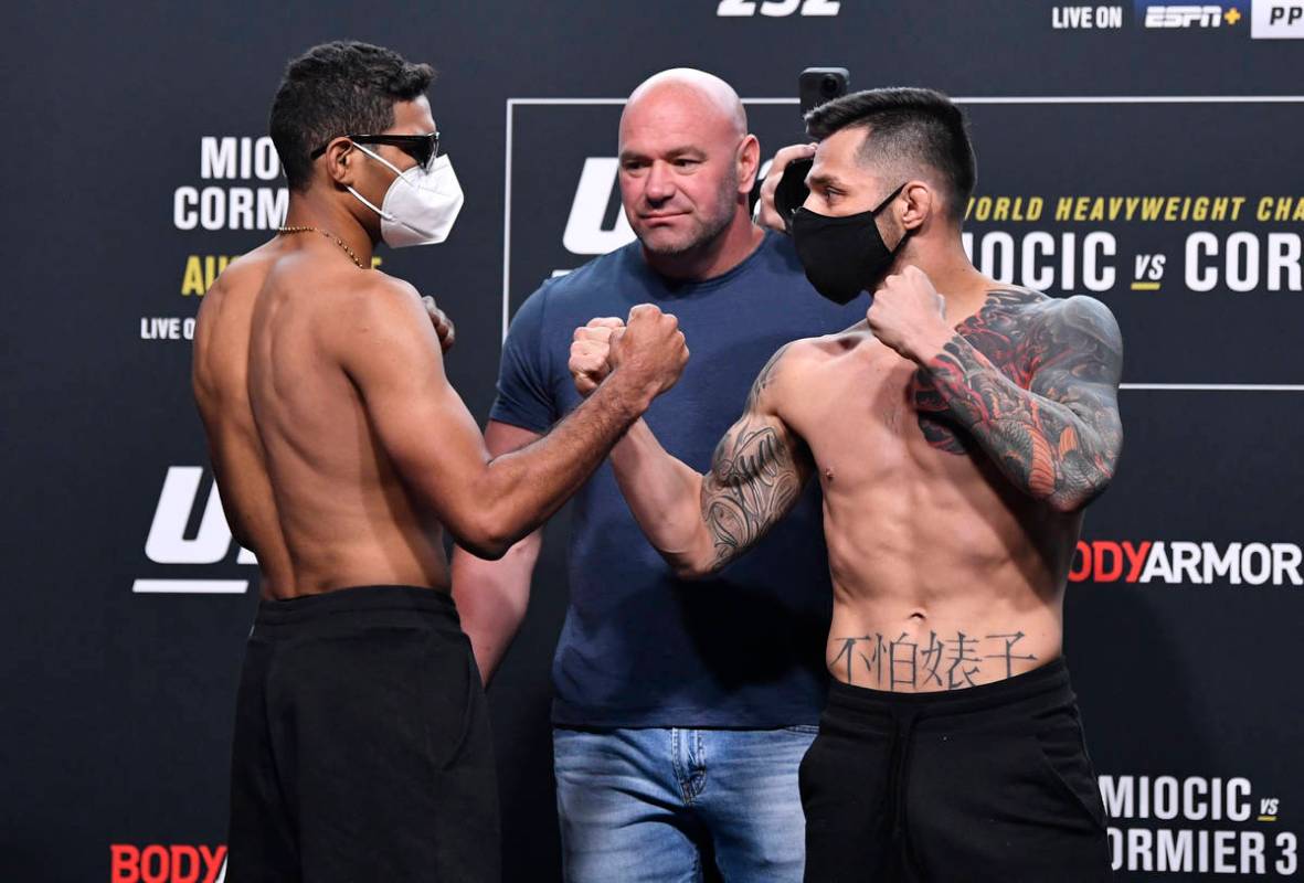 (L-R) Opponents Herbert Burns of Brazil and Daniel Pineda face off during the UFC 252 weigh-in ...