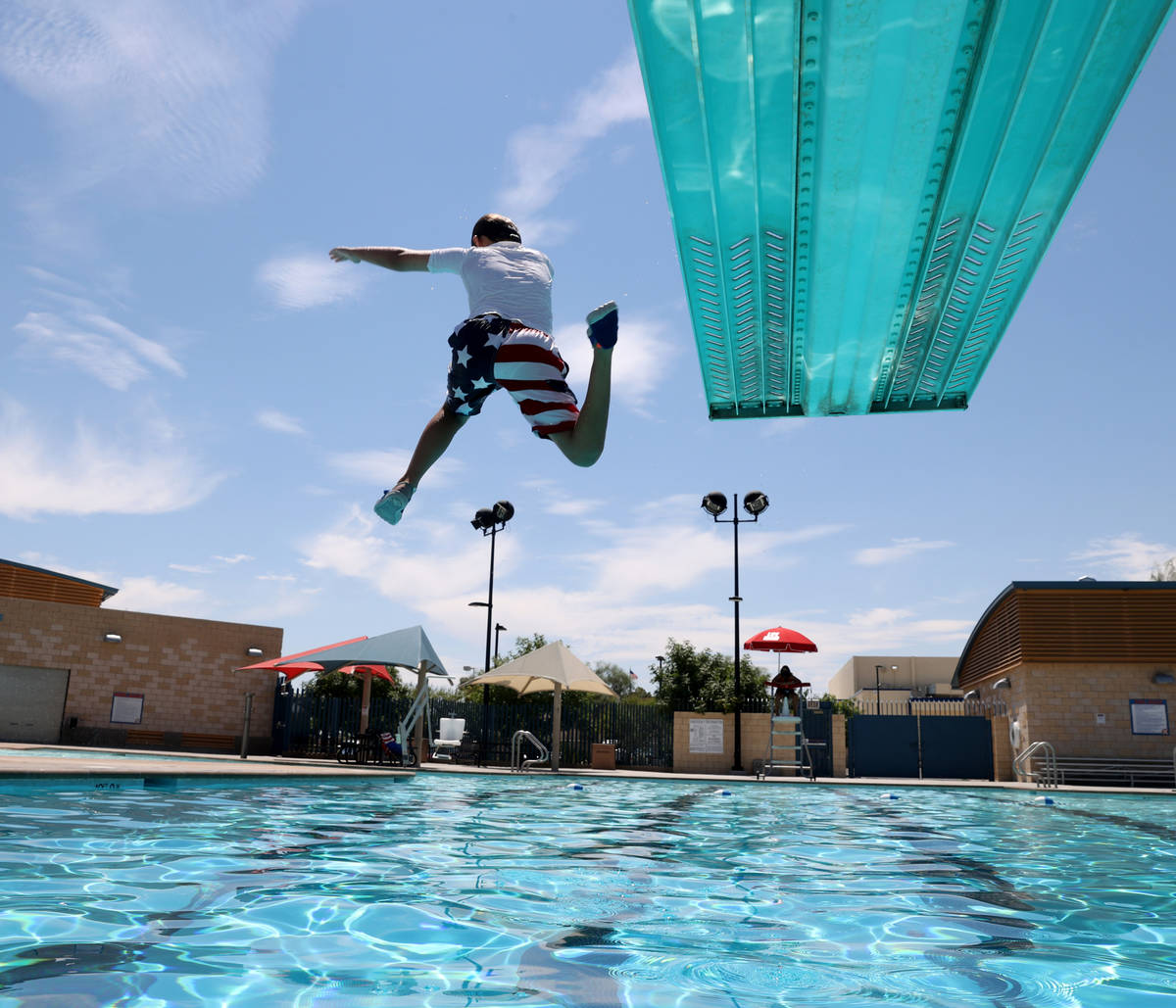 Logan Arnold, 10, of Las Vegas, jumps off the diving board at Garside Pool in Las Vegas Friday, ...