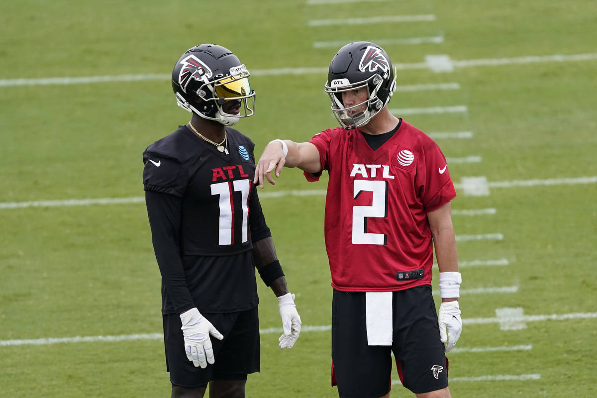 Atlanta Falcons wide receiver Julio Jones (11) and quarterback Matt Ryan (2) talk during an NFL ...