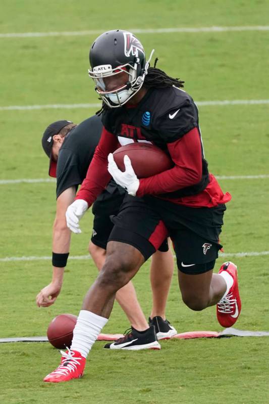 Atlanta Falcons running back Todd Gurley II (21) runs a drill during an NFL football training c ...