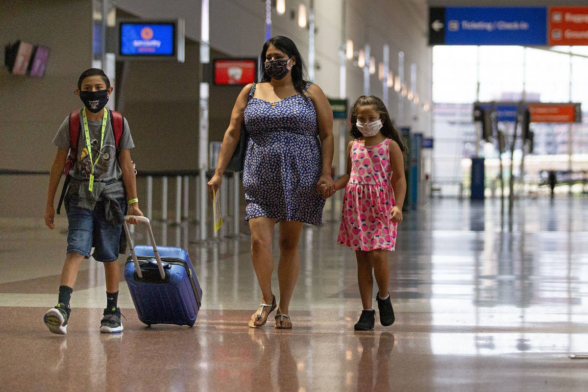 Evan York, 11, left, his mother Cynthia Noriega, center, and sister Sarah York, 7, right, walk ...