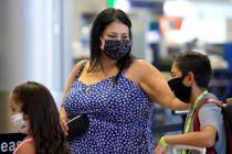 Cynthia Noriega touches her 11-year-old son Evan York's shoulder as they enter security at McCa ...