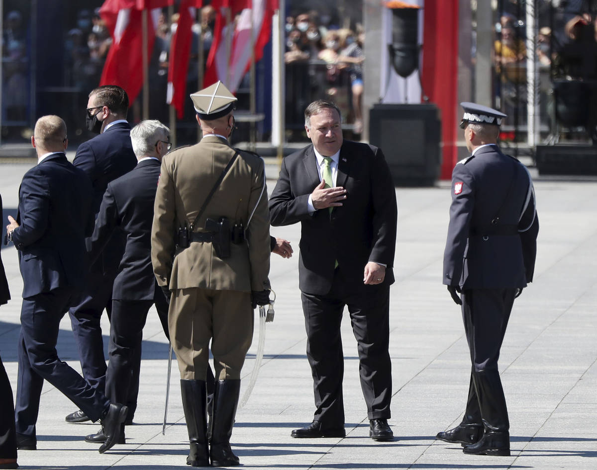 U.S. Secretary of State Mike Pompeo gestures toward Polish soldiers during ceremonies marking t ...