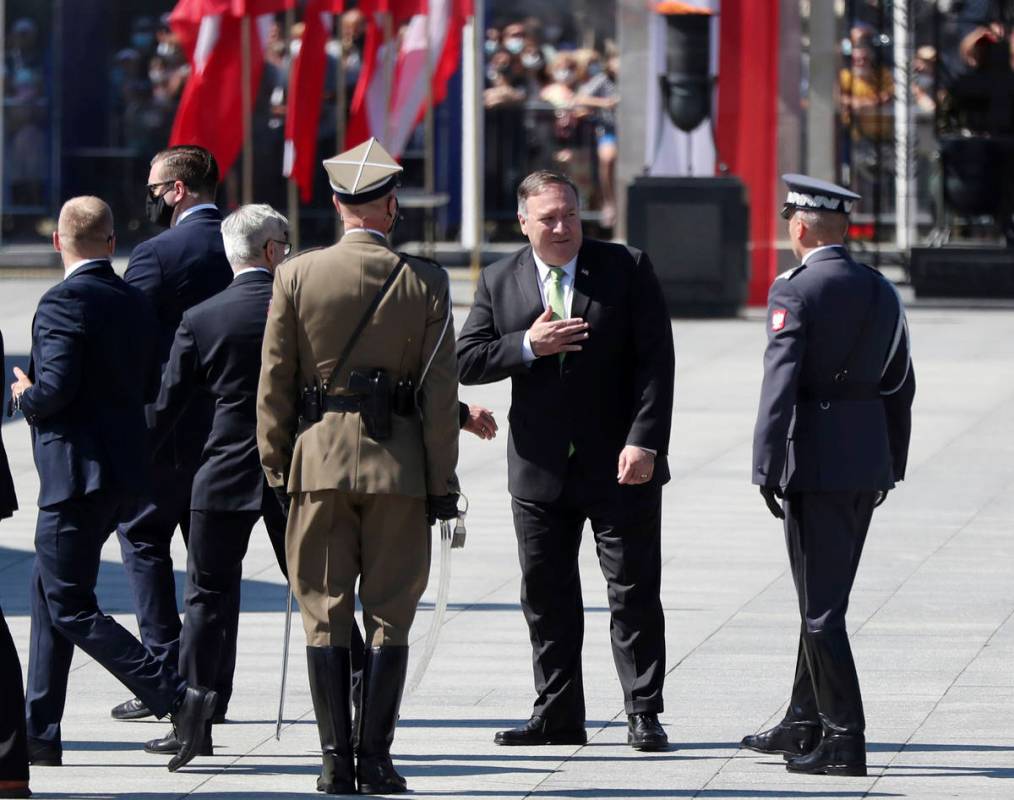 U.S. Secretary of State Mike Pompeo gestures toward Polish soldiers during ceremonies marking t ...