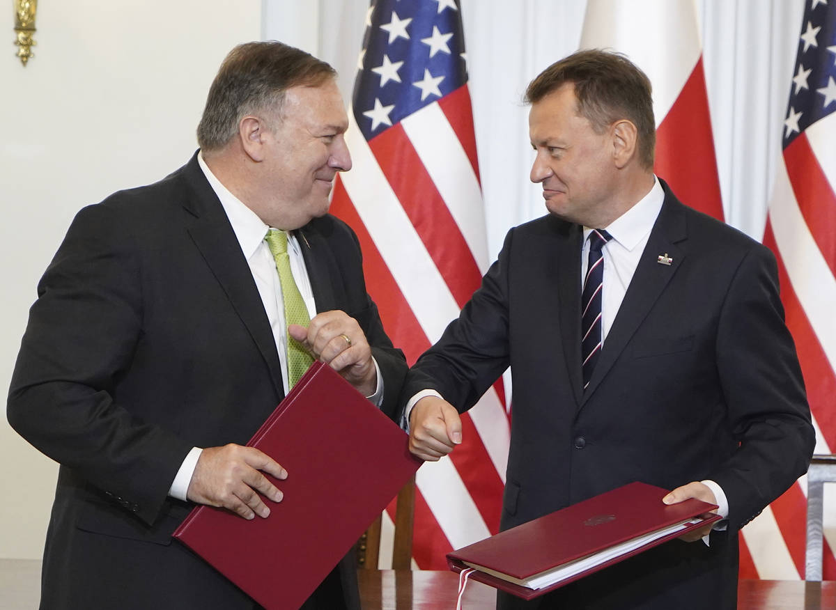 US Secretary of State Mike Pompeo, left, and Poland's Minister of Defence Mariusz Blaszczak gre ...