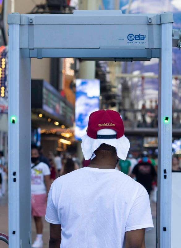 One person wears a sweat towel under his hat at Fremont Street Experience as temperatures reach ...