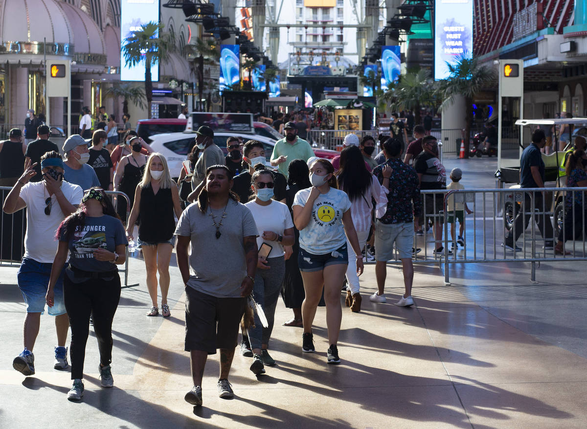 Tourists flocked to Fremont Street Experience despite a high temperature of 112 degrees on Satu ...