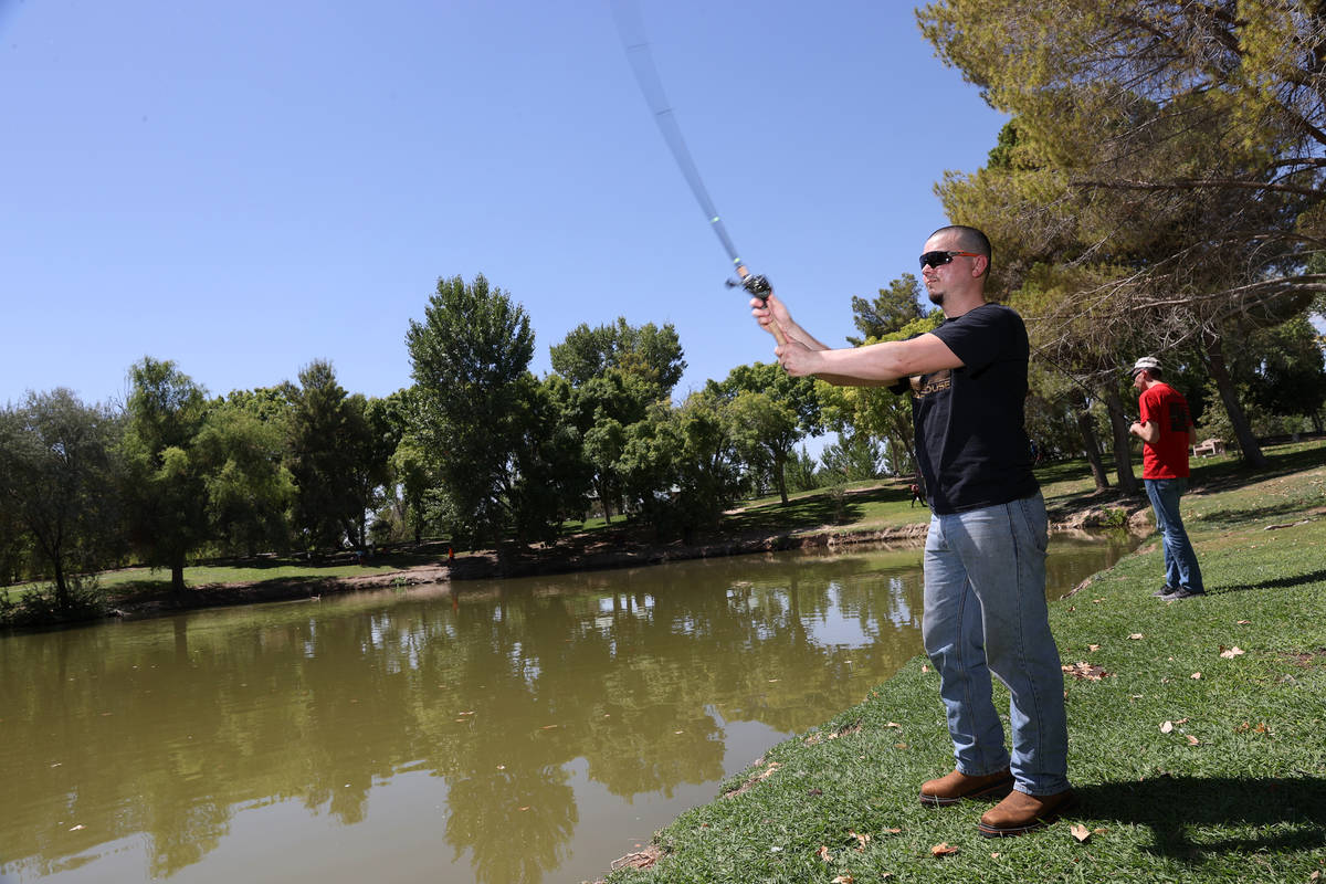 Shawn Strickler of Las Vegas, fishes at Floyd Lamb Park in Las Vegas, Saturday, Aug. 15, 2020. ...