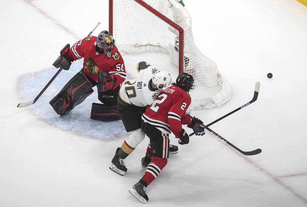 Vegas Golden Knights' Nicolas Roy (10) and Chicago Blackhawks' Duncan Keith (2) chase the rebou ...