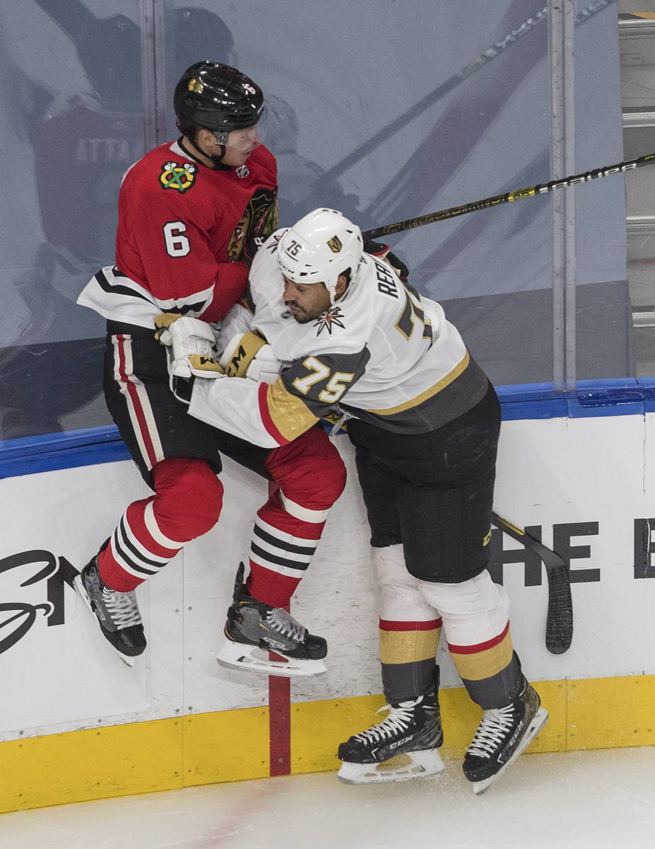 Vegas Golden Knights' Ryan Reaves (75) checks Chicago Blackhawks' Olli Maatta (6) during first- ...