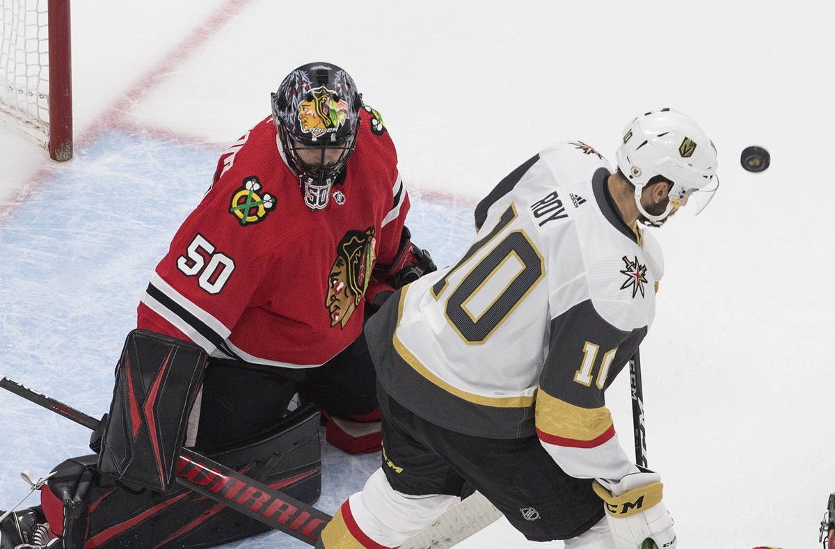 Vegas Golden Knights' Nicolas Roy (10) looks for the rebound off Chicago Blackhawks goalie Core ...