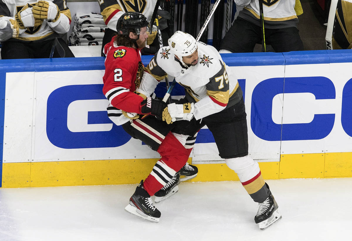 Vegas Golden Knights' Ryan Reaves (75) checks Chicago Blackhawks' Duncan Keith (2) during first ...