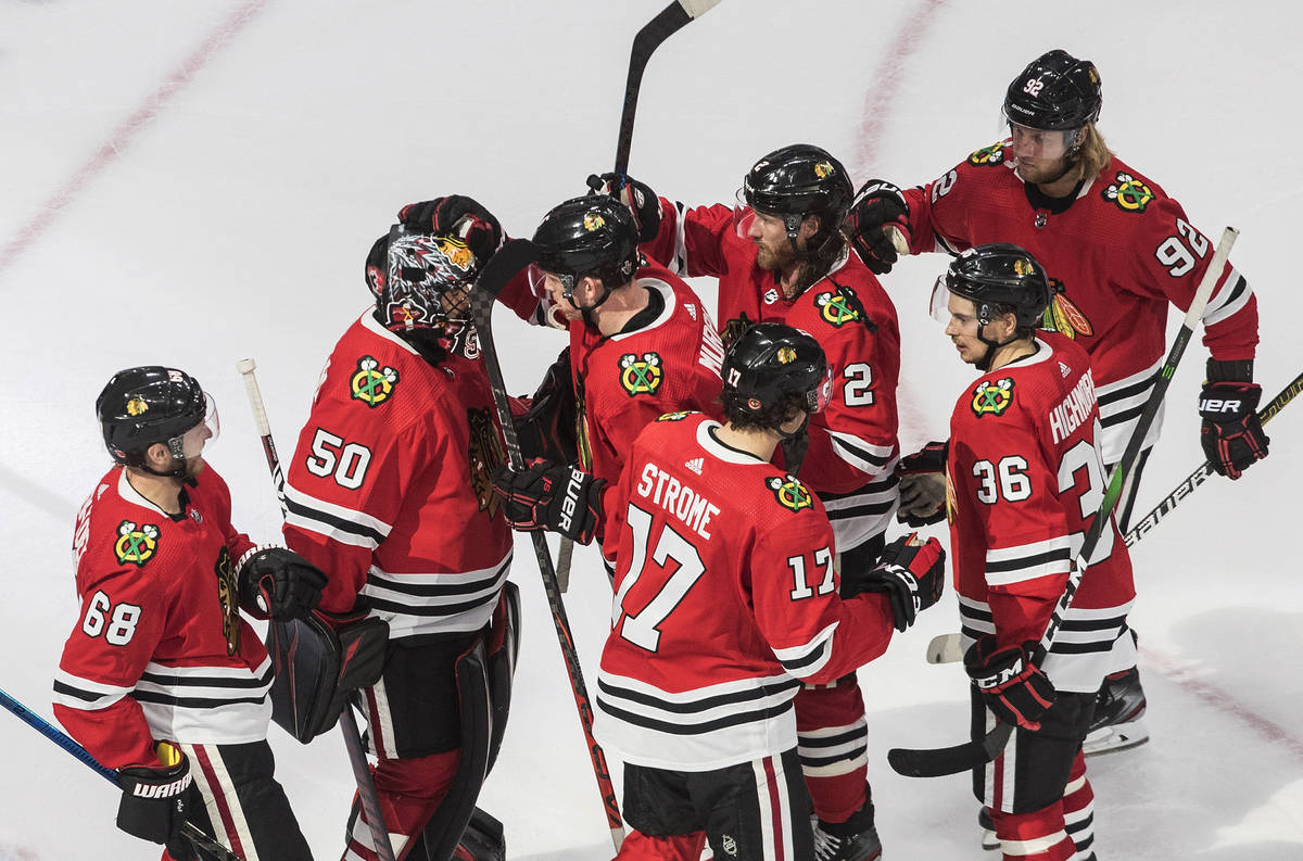 Chicago Blackhawks goalie Corey Crawford (50) and teammates celebrate a win over the Vegas Gold ...