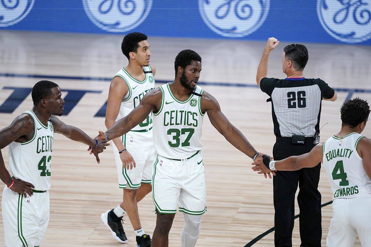 Boston Celtics' Semi Ojeleye (37) is congratulated by teammates Javonte Green and Carsen Edward ...