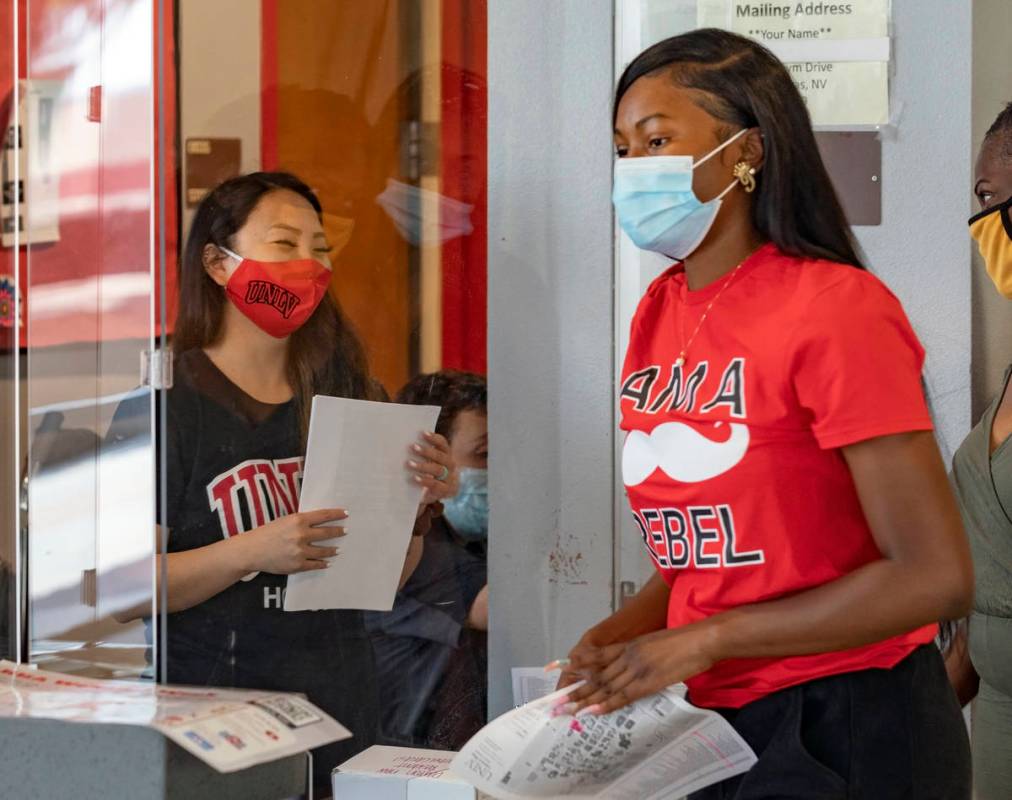 Mail clerk Rachel Deguchi, left, greets UNLV freshman Tyra Bevans, 18, of Los Angeles, during m ...