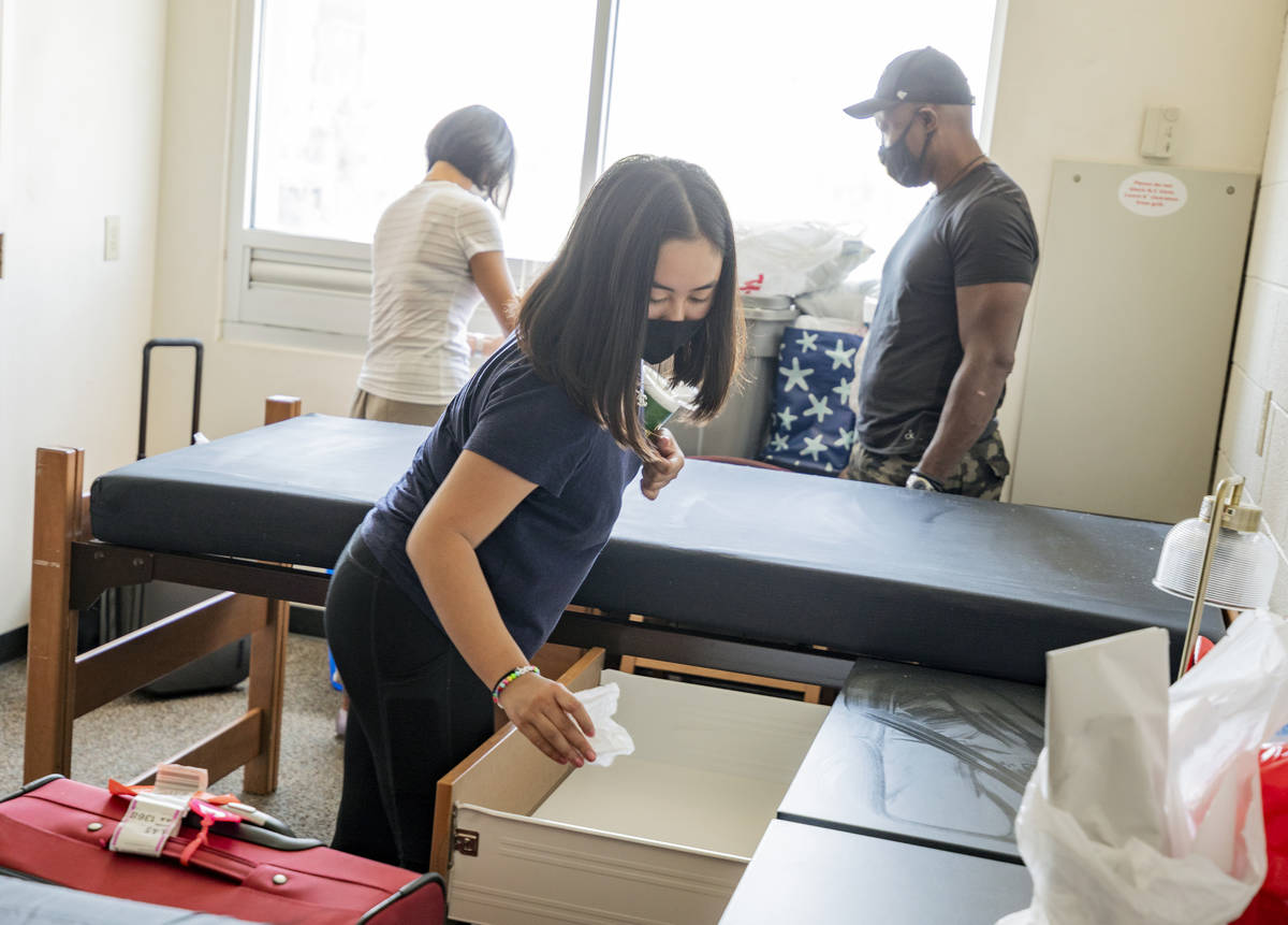 UNLV freshman Lia Cheung, 18, of Miami, sanitizes her furniture in her dorm at Dayton Hall, in ...