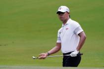 Si Woo Kim watches his chip shot to the fifth green during the final round of the Wyndham Champ ...