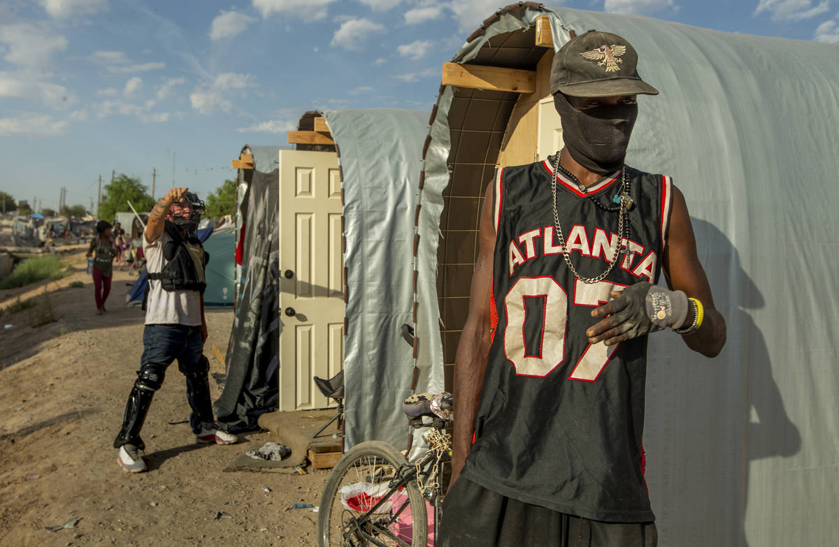 New hut resident Alteri Burks talks after members of Food Not Bombs and the Sidewalk Project co ...