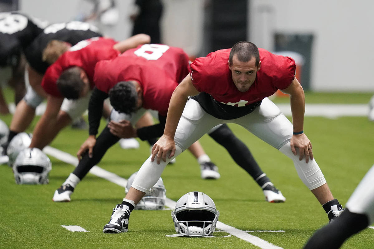 Las Vegas Raiders quarterback Derek Carr (4) stretches during an NFL football training camp pra ...