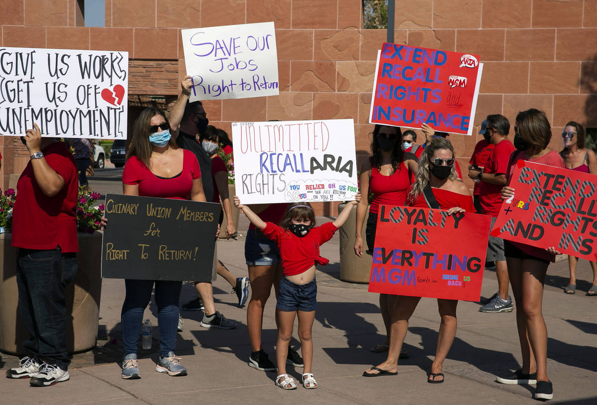 Charlie Gonzalez, 6, center, joins her mother Alana, center standing behind her, and union memb ...