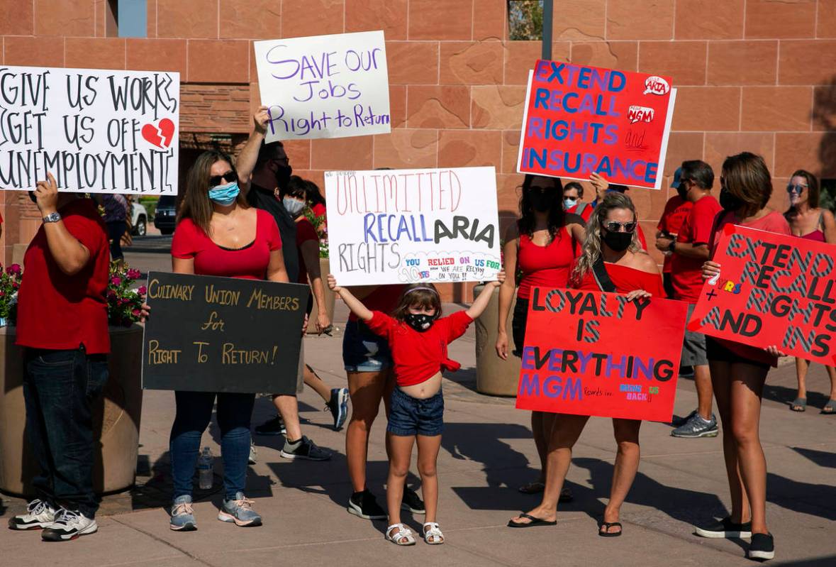 Charlie Gonzalez, 6, center, joins her mother Alana, center standing behind her, and union memb ...