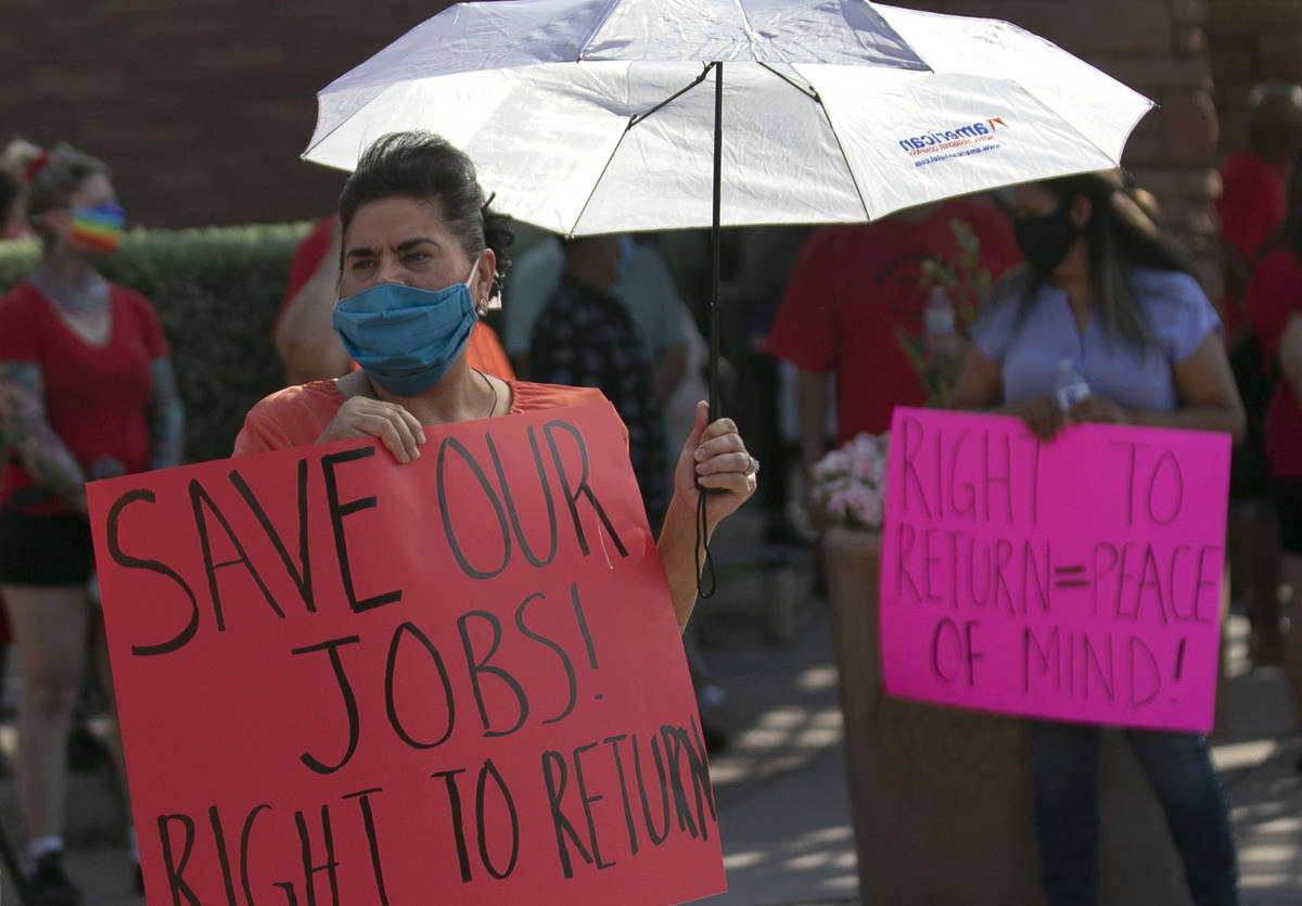 Union members, including Gabriela Rivera, rally outside of the Clark County Commission Building ...