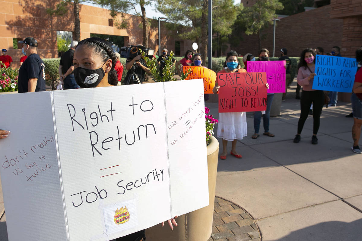 Michelle Weigum, left, and union members rally outside of the Clark County Commission Building ...